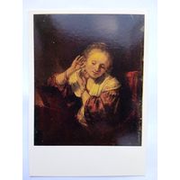 Рембрандт. Молодая женщина, примеряющая серьги
